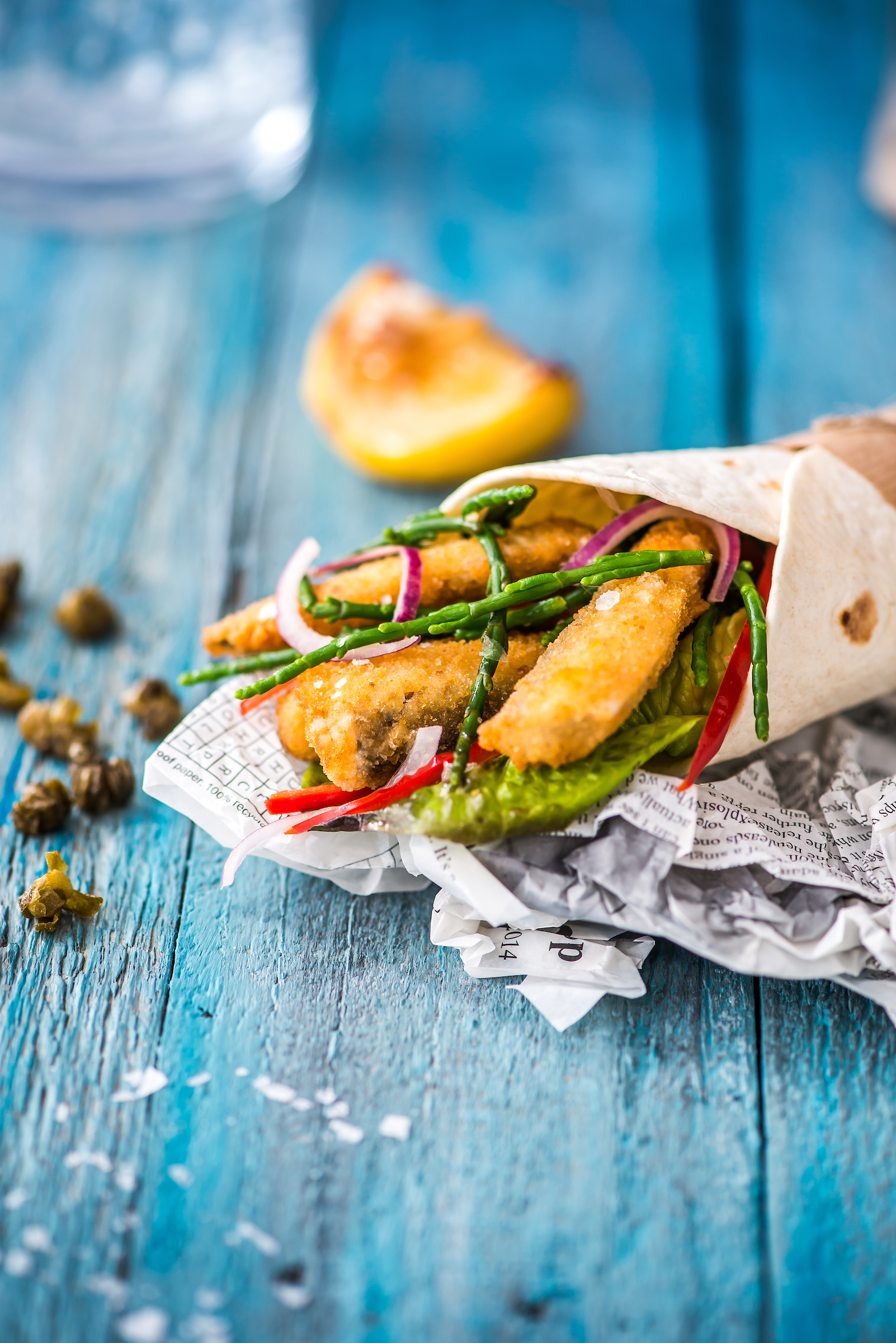 MSC Coated whitebait in a wrap on a blue wooden table