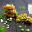 Vibrant green Pea and Mint Fritters on a black serving board